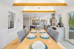 Beamed dining room with open view to kitchen
